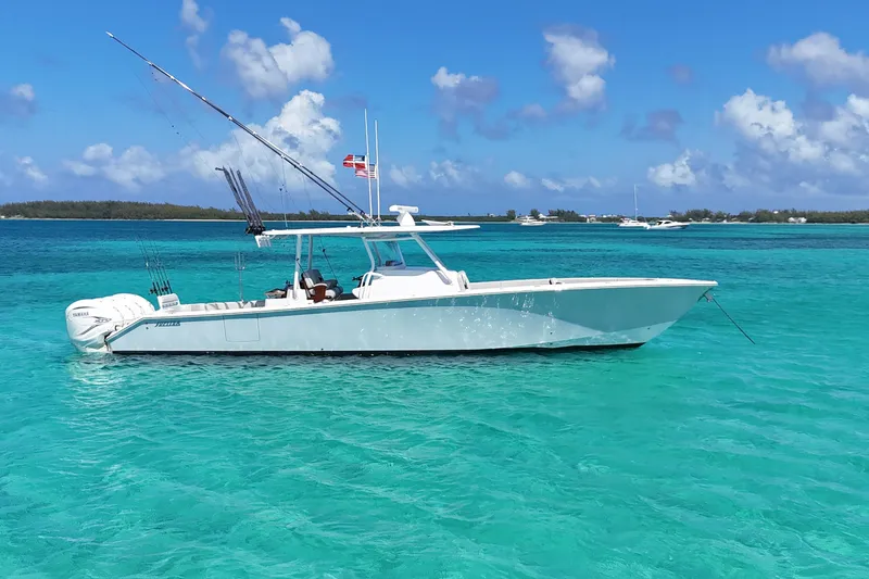 The Image of 2021 Jupiter 43 boat anchored in clear turquoise waters under a blue sky. - 0