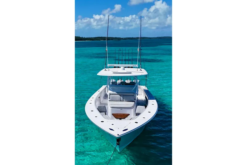 Slide: The Image of 2021 Jupiter 43 boat on clear turquoise water under a blue sky. - 2