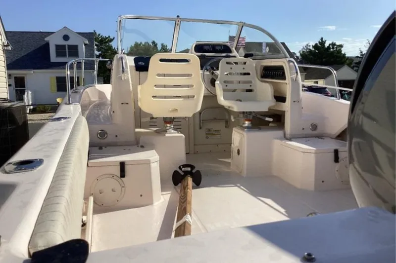 Slide: The Image of 2013 Grady-White Adventure 208 boat interior with seating and steering wheel. - 2