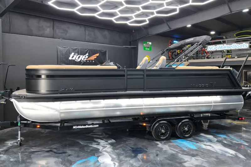 The Image of 2026 Viaggio Lago Z-U 24 pontoon boat displayed indoors on a trailer. - 1