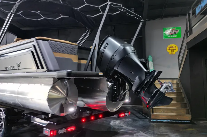 Slide: The Image of 2026 Viaggio Lago Z-U 24 pontoon boat with Suzuki outboard motor in showroom. - 13