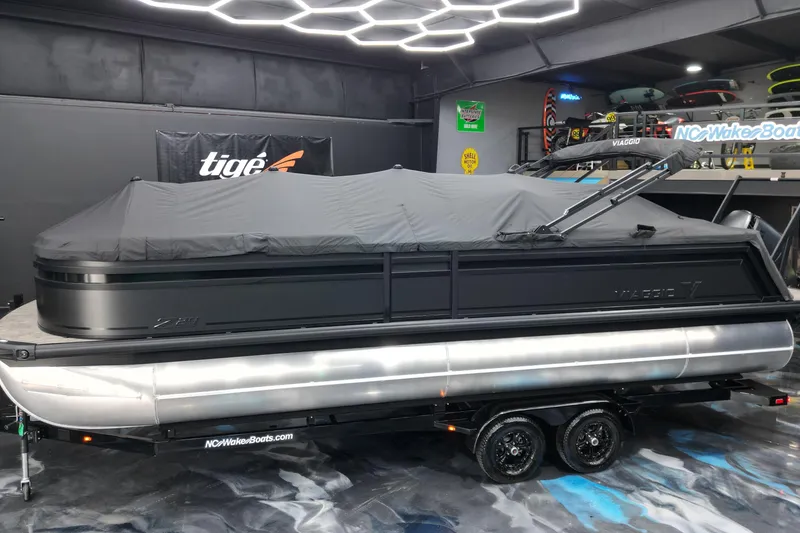 Slide: The Image of 2026 Viaggio Lago Z-U 24 pontoon boat covered in a showroom. - 22