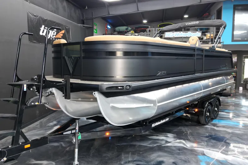Slide: The Image of 2026 Viaggio Lago Z-U 24 pontoon boat on trailer in showroom. - 5