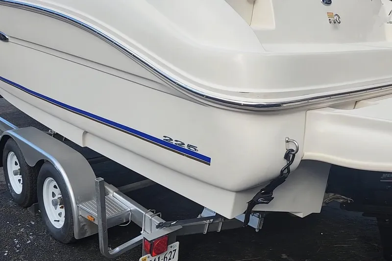 Slide: The Image of 2003 Sea Ray 225 Weekender boat on trailer, rear view with blue stripe. - 17