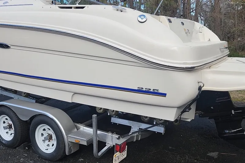 Slide: The Image of 2003 Sea Ray 225 Weekender boat on trailer, side view, outdoors. - 18