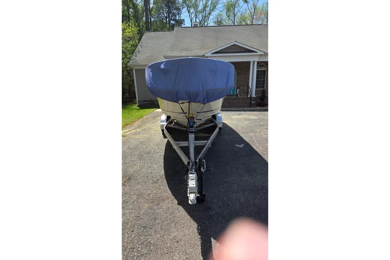 Slide: The Image of 2003 Sea Ray 225 Weekender boat on trailer, covered, parked in driveway. - 25