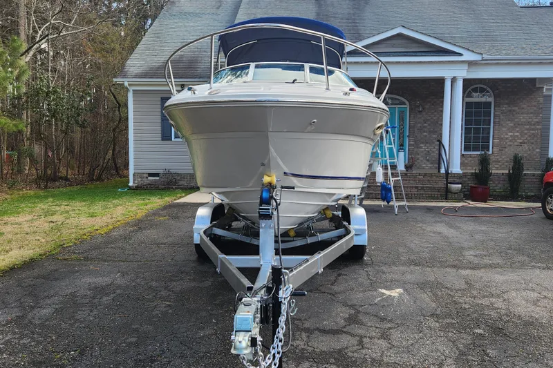 Slide: The Image of 2003 Sea Ray 225 Weekender boat on trailer in front of house. - 4