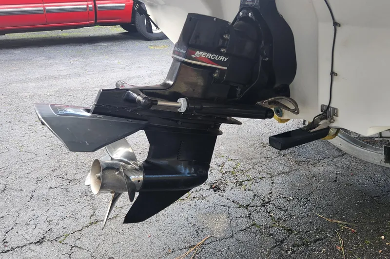 Slide: The Image of Outboard motor of a 2003 Sea Ray 225 Weekender on a paved surface. - 6