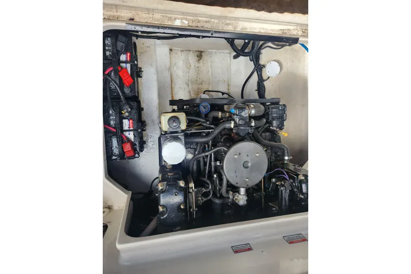 Slide: The Image of Engine compartment of a 2003 Sea Ray 225 Weekender boat, showcasing mechanical components. - 7