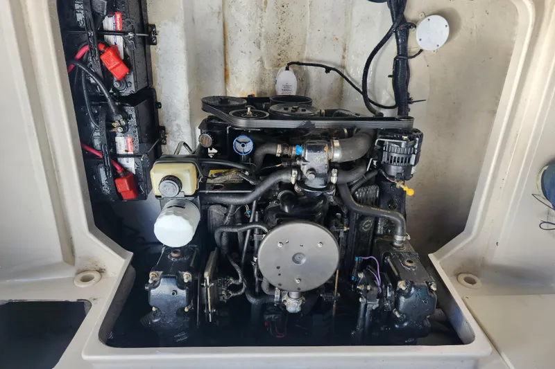 Slide: The Image of Engine compartment of a 2003 Sea Ray 225 Weekender boat, showcasing mechanical components. - 8
