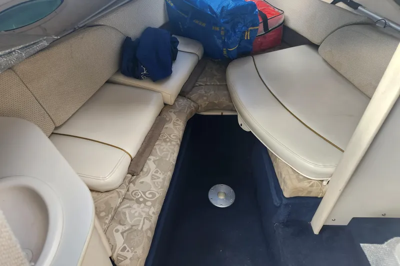 Slide: The Image of Interior cabin of a 2003 Sea Ray 225 Weekender boat with seating and storage. - 9