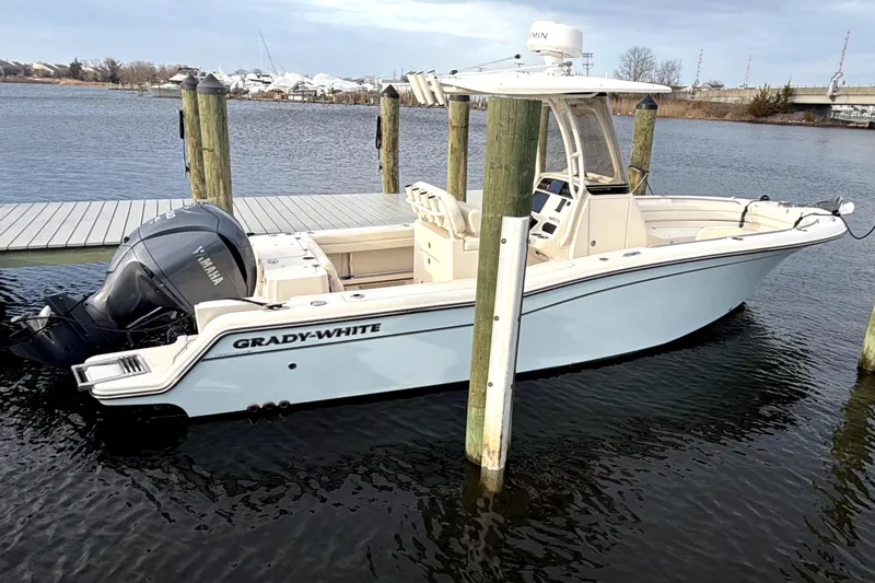The Image of 2022 Grady-White Fisherman 236 boat docked on calm water. - 0