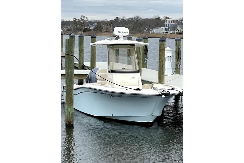 Slide: The Image of 2022 Grady-White Fisherman 236 boat docked at marina with Garmin equipment. - 2