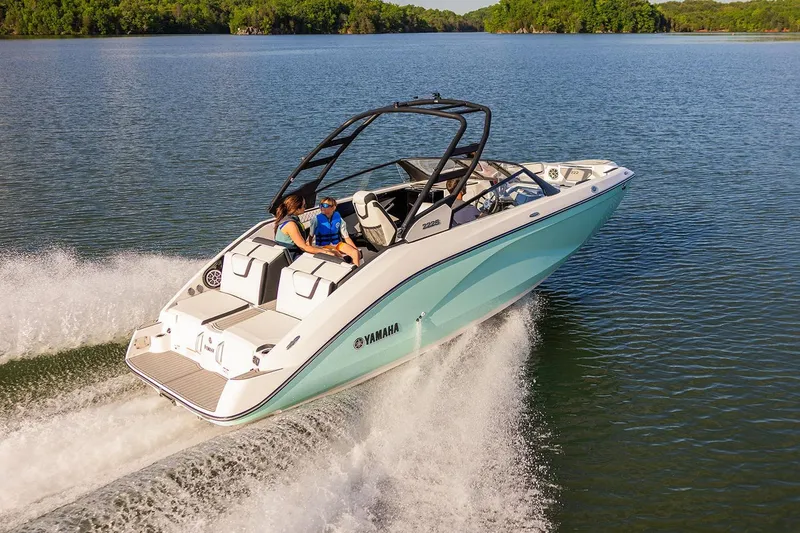 Slide: The Image of Manufacturer Provided Image: 2026 Yamaha Boats 222S cruising on a serene lake with passengers enjoying the ride. - 2