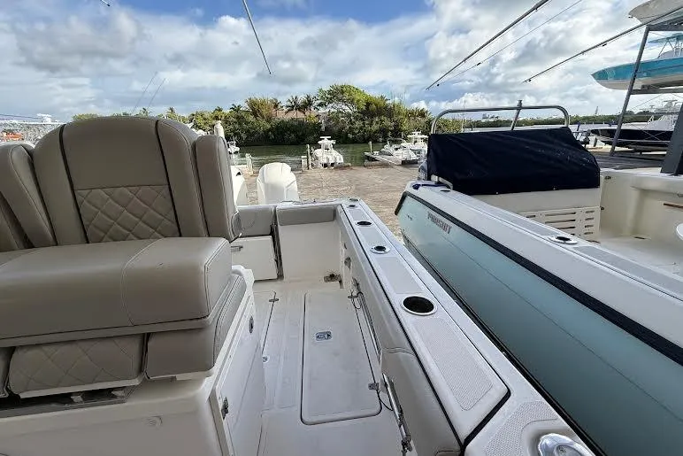 Slide: The Image of Manufacturer Provided Image: 2022 Pursuit S 268 Sport boat cruising on clear blue water. - 28