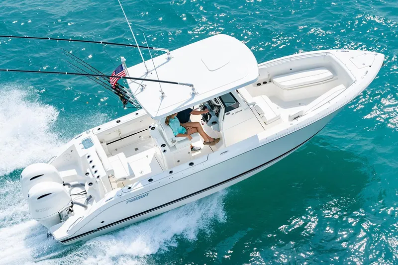 Slide: The Image of 2022 Pursuit S 268 Sport boat interior with clear sky and marina view. - 4