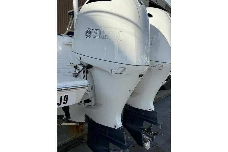 Slide: The Image of Manufacturer Provided Image: 2022 Pursuit S 268 Sport boat with white seating and dual outboard motors. - 41