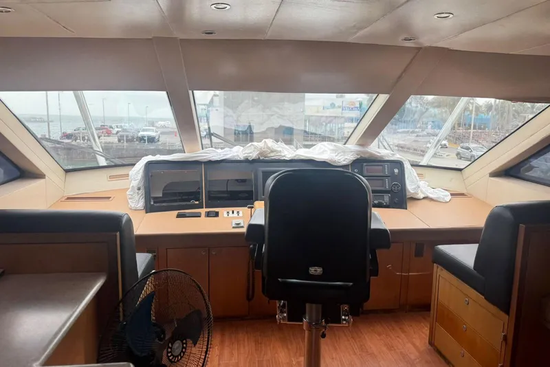 Slide: The Image of Interior view of a 2007 Hatteras yacht helm with panoramic windows. - 13