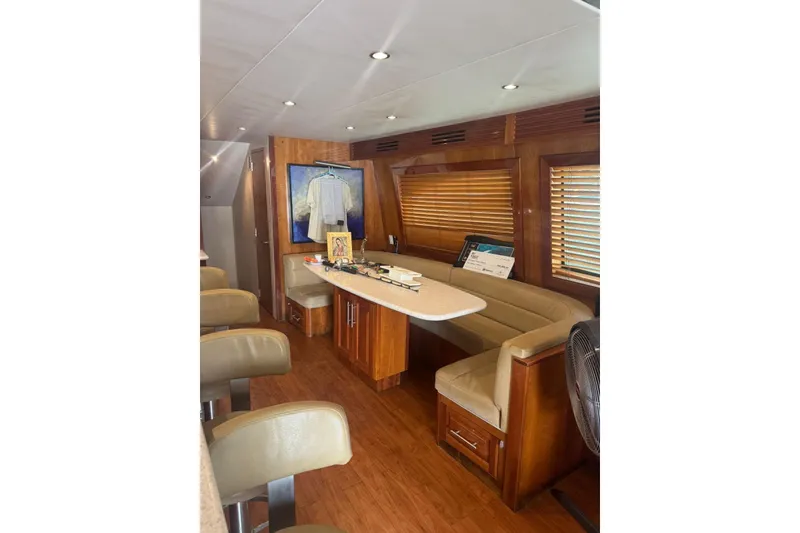 Slide: The Image of Luxurious 2007 Hatteras yacht interior with wooden furnishings and cozy seating area. - 15