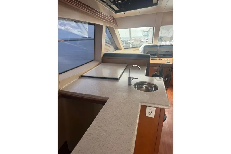 Slide: The Image of Interior of a 2007 Hatteras yacht featuring a sleek kitchen counter and sink. - 16