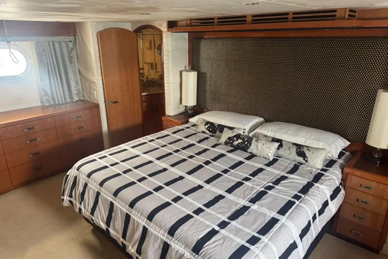 Slide: The Image of Luxurious 2007 Hatteras yacht bedroom with elegant bedding and wooden furnishings. - 20