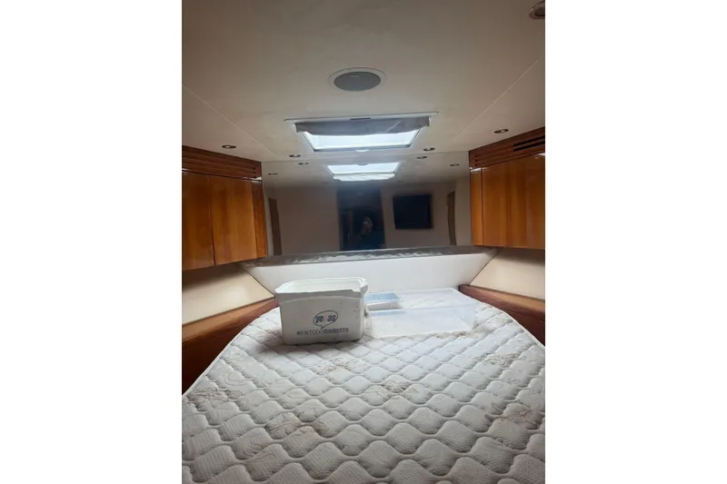 Slide: The Image of Interior of a 2007 Hatteras yacht cabin with skylights and wooden cabinets. - 22