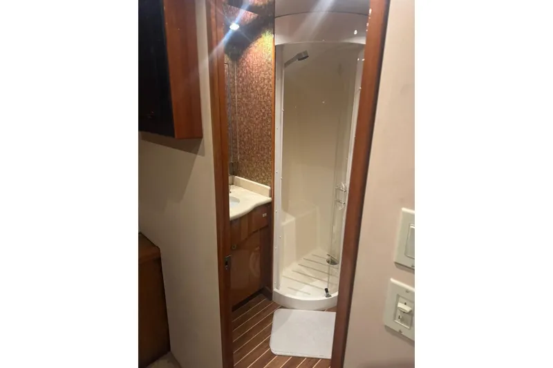 Slide: The Image of Luxurious 2007 Hatteras yacht bathroom with modern shower and wooden accents. - 24