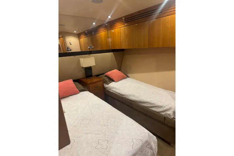 Slide: The Image of Luxurious 2007 Hatteras yacht cabin with twin beds and elegant wood cabinetry. - 25