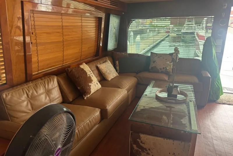 Slide: The Image of Luxurious 2007 Hatteras yacht interior with leather seating, wooden blinds, and glass table. - 26