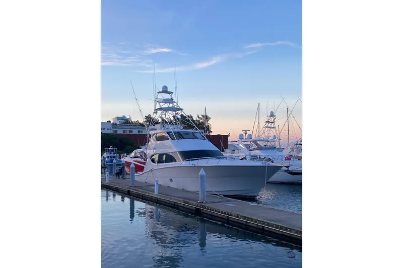 Slide: The Image of Luxury 2007 Hatteras yacht docked at marina during sunset, showcasing sleek design. - 3
