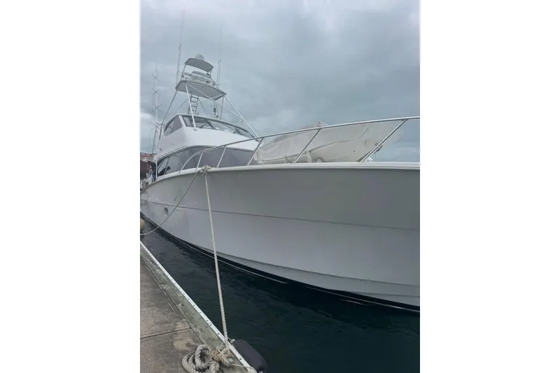 Slide: The Image of 2007 Hatteras yacht docked, showcasing sleek design under cloudy skies. - 4