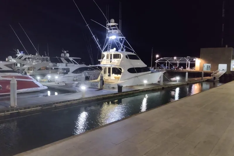 Slide: The Image of Night view of a 2007 Hatteras yacht docked at a marina, illuminated by lights. - 8