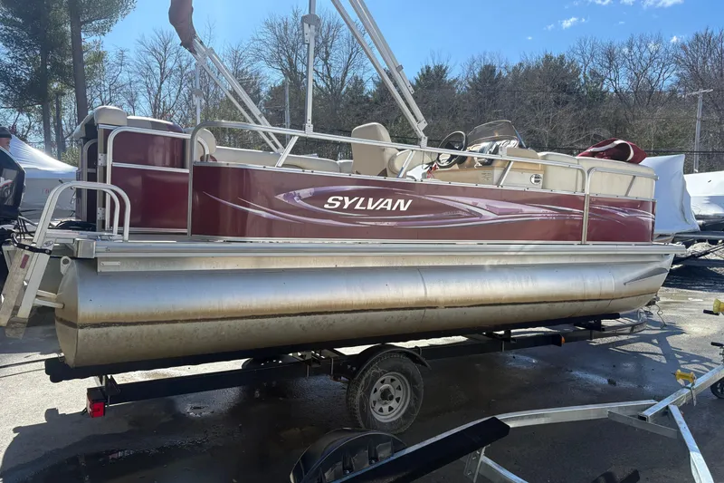 The Image of 2011 Sylvan 820 Mirage Cruise pontoon boat on trailer, parked outdoors. - 0