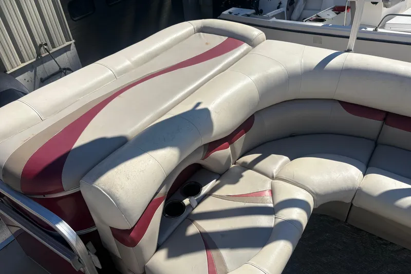 Slide: The Image of 2011 Sylvan 820 Mirage Cruise boat interior with white and maroon seating. - 10