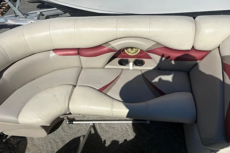 Slide: The Image of 2011 Sylvan 820 Mirage Cruise boat interior with beige and maroon seating. - 11