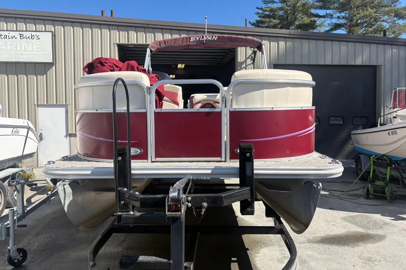 Slide: The Image of 2011 Sylvan 820 Mirage Cruise pontoon boat on trailer outside a marine shop. - 2