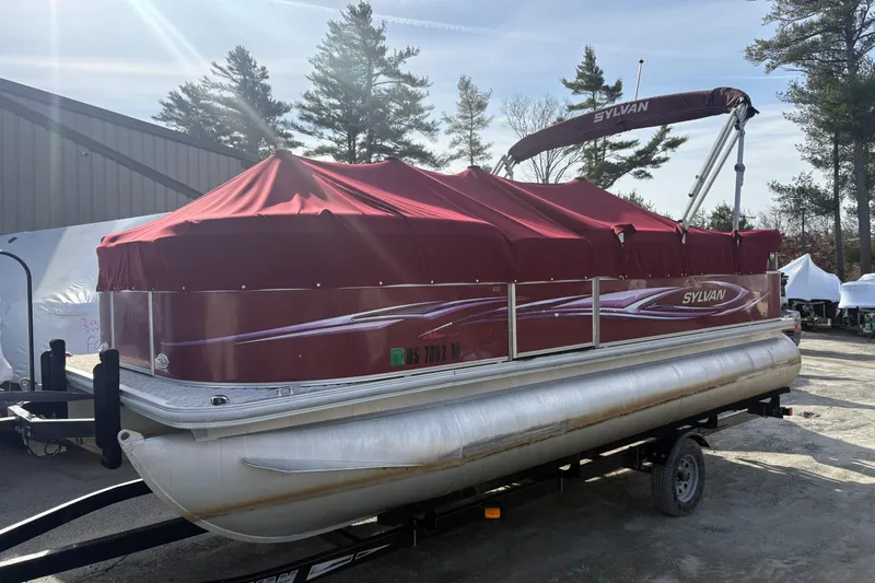 Slide: The Image of 2011 Sylvan 820 Mirage Cruise pontoon boat with red cover on trailer. - 4