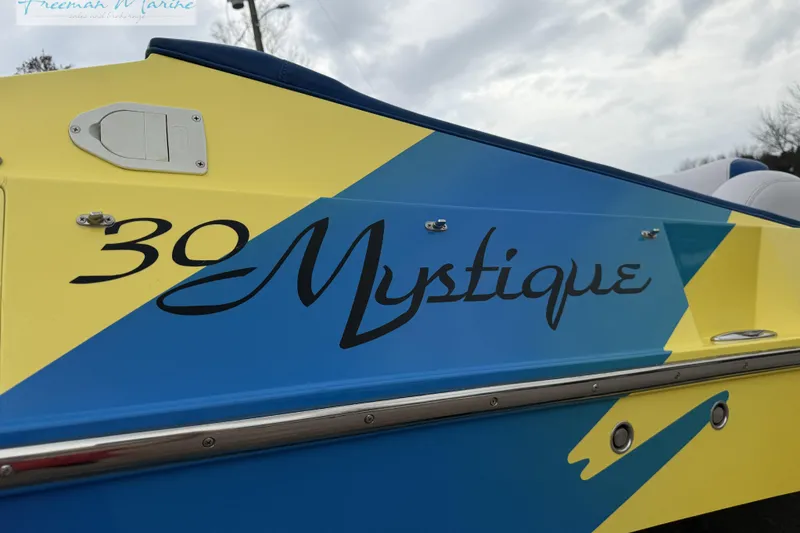 Slide: The Image of 2000 Cigarette 30' Mystique boat with vibrant blue and yellow design. - 11