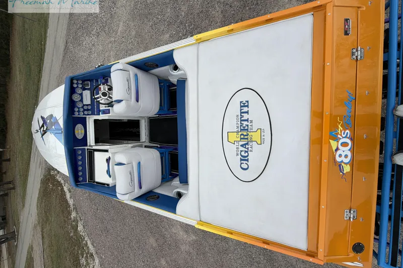 Slide: The Image of 2000 Cigarette 30' Mystique boat interior with white and blue seating, orange accents. - 14