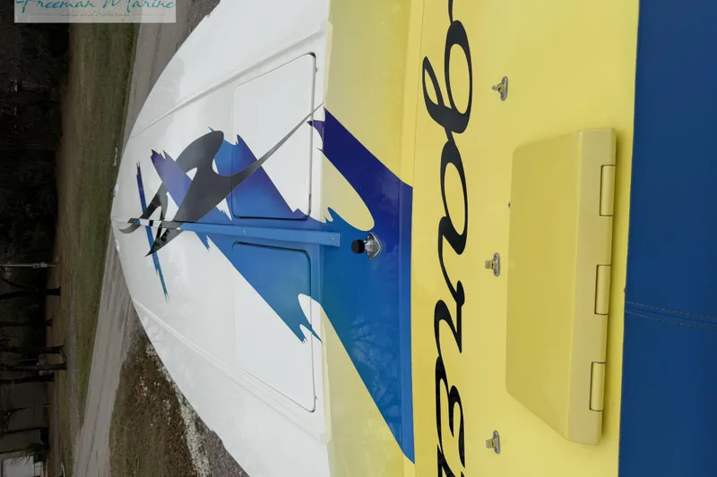 Slide: The Image of 2000 Cigarette 30' Mystique boat with vibrant blue and yellow design. - 16