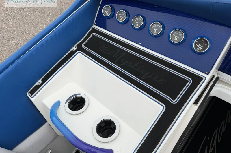 Slide: The Image of Dashboard of a 2000 Cigarette 30' Mystique boat with gauges and cup holders. - 18