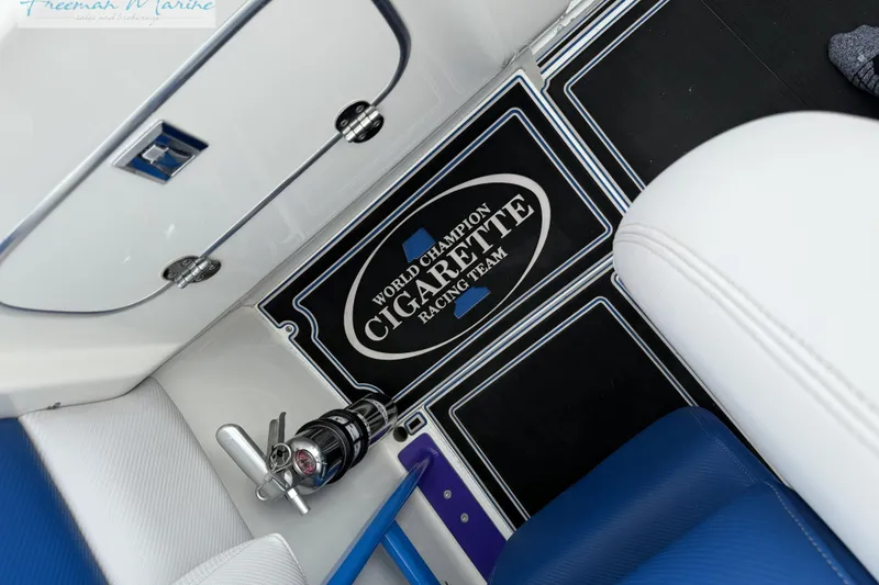Slide: The Image of Interior of 2000 Cigarette 30' Mystique boat with branded floor mat. - 19