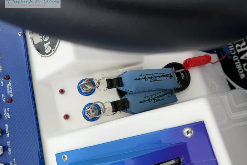 Slide: The Image of Control panel of a 2000 Cigarette 30' Mystique boat with key switches and safety lanyard. - 21