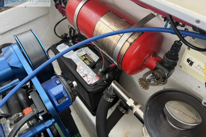 Slide: The Image of Engine compartment of a 2000 Cigarette 30' Mystique boat with fire extinguisher and battery. - 24