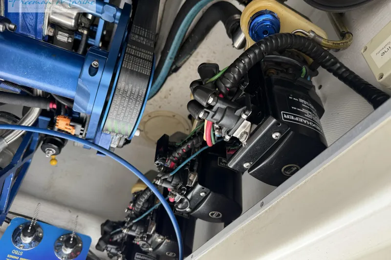 Slide: The Image of Engine components of a 2000 Cigarette 30' Mystique boat, featuring belts and wiring. - 25