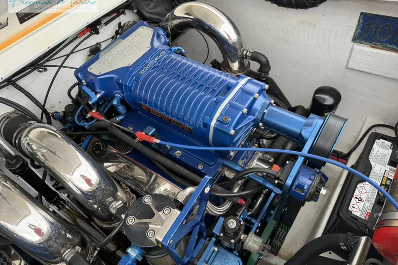 Slide: The Image of Engine of a 2000 Cigarette 30' Mystique boat with blue Whipple supercharger. - 27