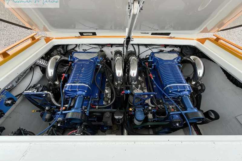 Slide: The Image of Twin blue engines in a 2000 Cigarette 30' Mystique boat, showcasing powerful performance. - 29
