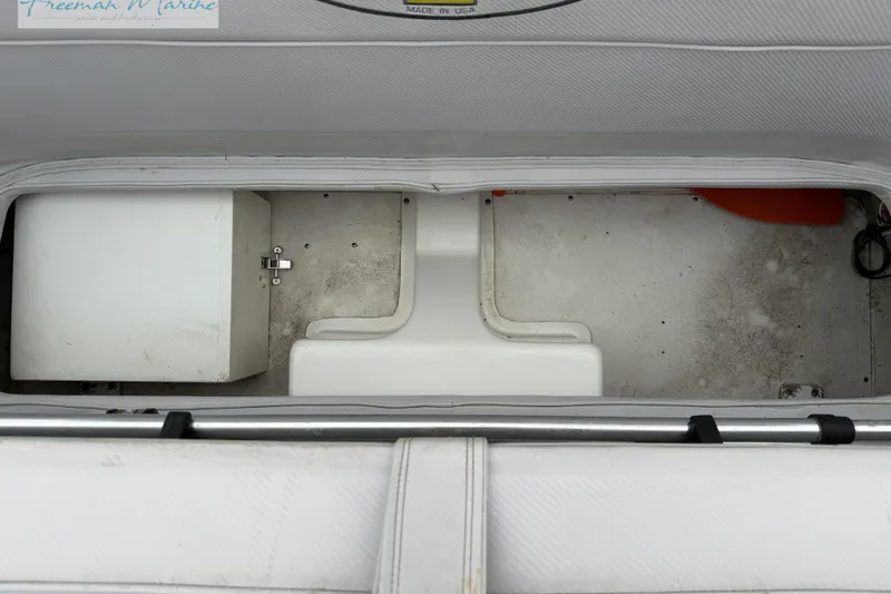 Slide: The Image of Storage compartment of a 2000 Cigarette 30' Mystique boat, featuring a white interior. - 30