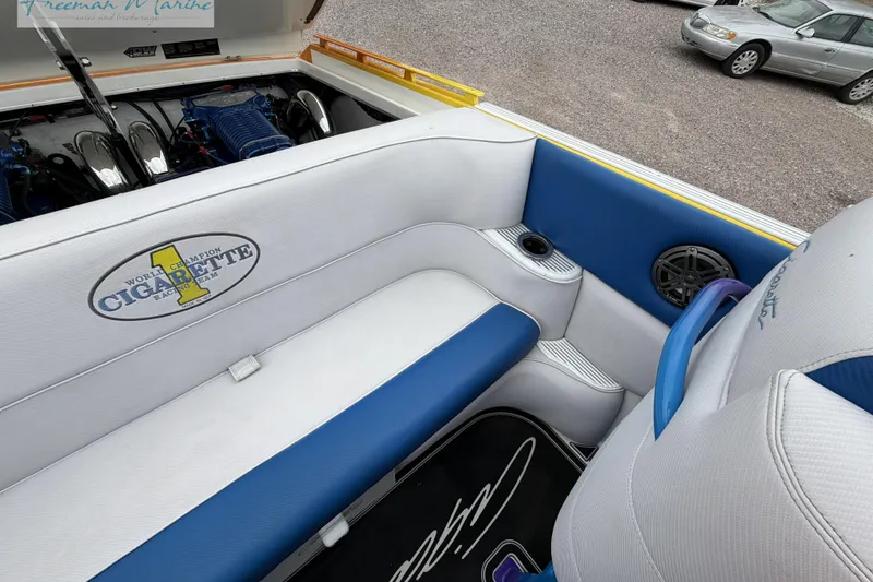Slide: The Image of Interior of a 2000 Cigarette 30' Mystique boat with blue and white seating. - 32