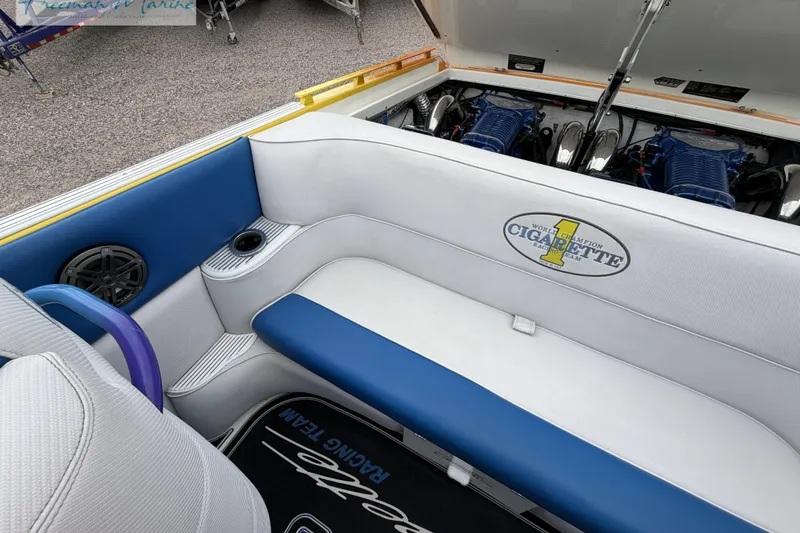 Slide: The Image of 2000 Cigarette 30' Mystique boat interior with blue and white seating and visible engines. - 33